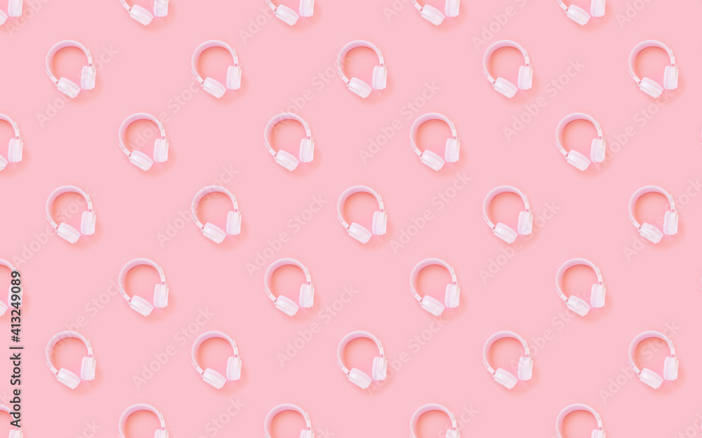 Pink headphones on a pink background. Pattern. Concept for music, podcasts, audiobooks. Top view, copy space.