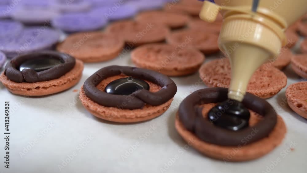 Cooking brown macarons, close-up of the chef stuffing them. Copy space. Cooking brown macarons, close-up of the chef stuffing them. Copy space.