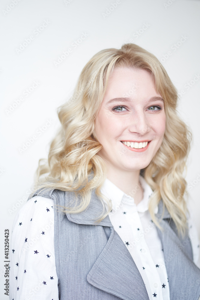 Beautiful young smiling happy woman on grey background, business portrait of a specialist Beautiful young smiling happy woman on grey background, business portrait of a specialist