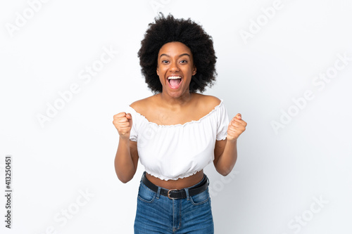 Young African American woman isolated on white background celebrating a victory in winner position