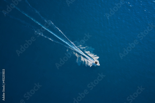 Aerial view of luxury floating ship at sunset, blue sea. Yacht at the sea in Europe. Top view from drone of yacht. High altitude air view © Berg