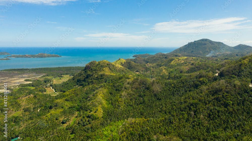 The mountains and hills with tropical forest with blue sea. Tropical landscape, Mindanao, Philippines. The mountains and hills with tropical forest with blue sea. Tropical landscape, Mindanao, Philippines.