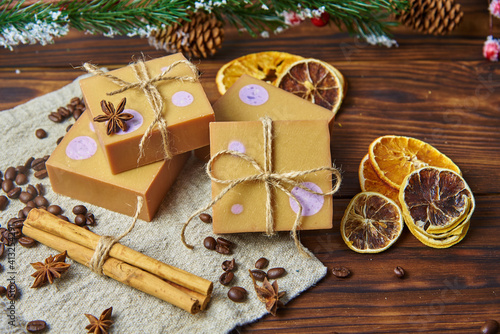 Bright handmade soap, various spices on the wooden countertop. Healthy lifestyle, natural products.