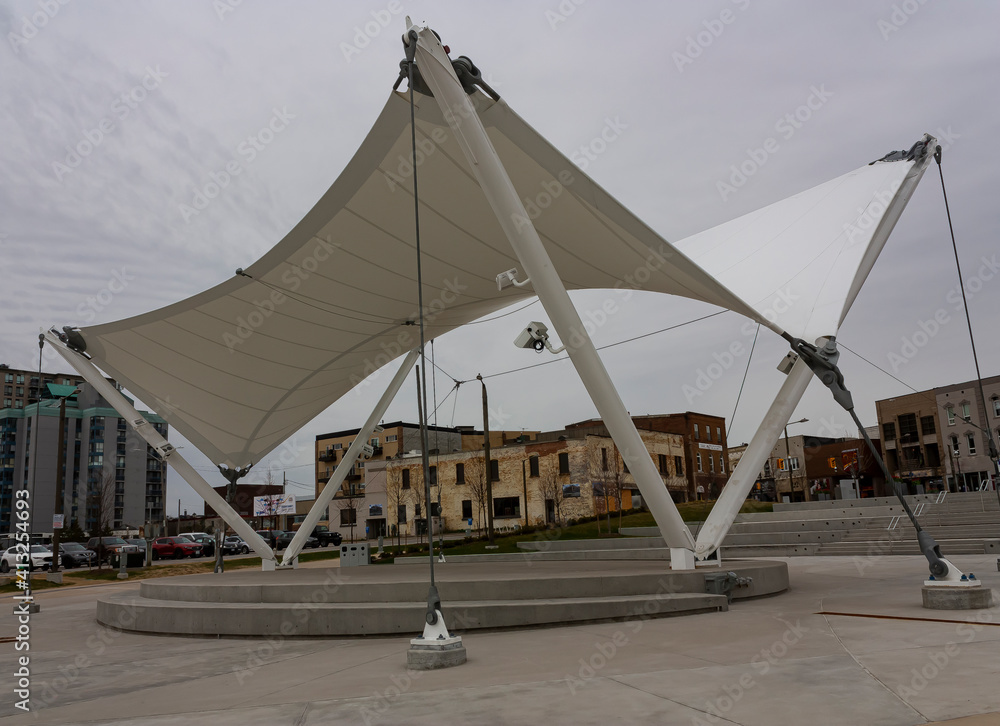 A tensile structure comprising a membrane roof steel columns and cables