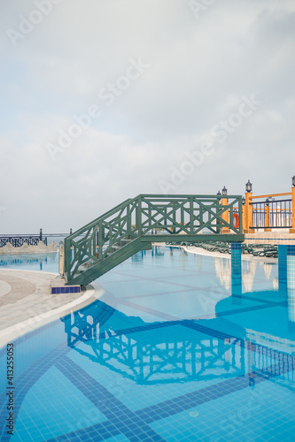 Large pool with clear blue water and relaxation areas. Swimming area on the territory of the hotel.