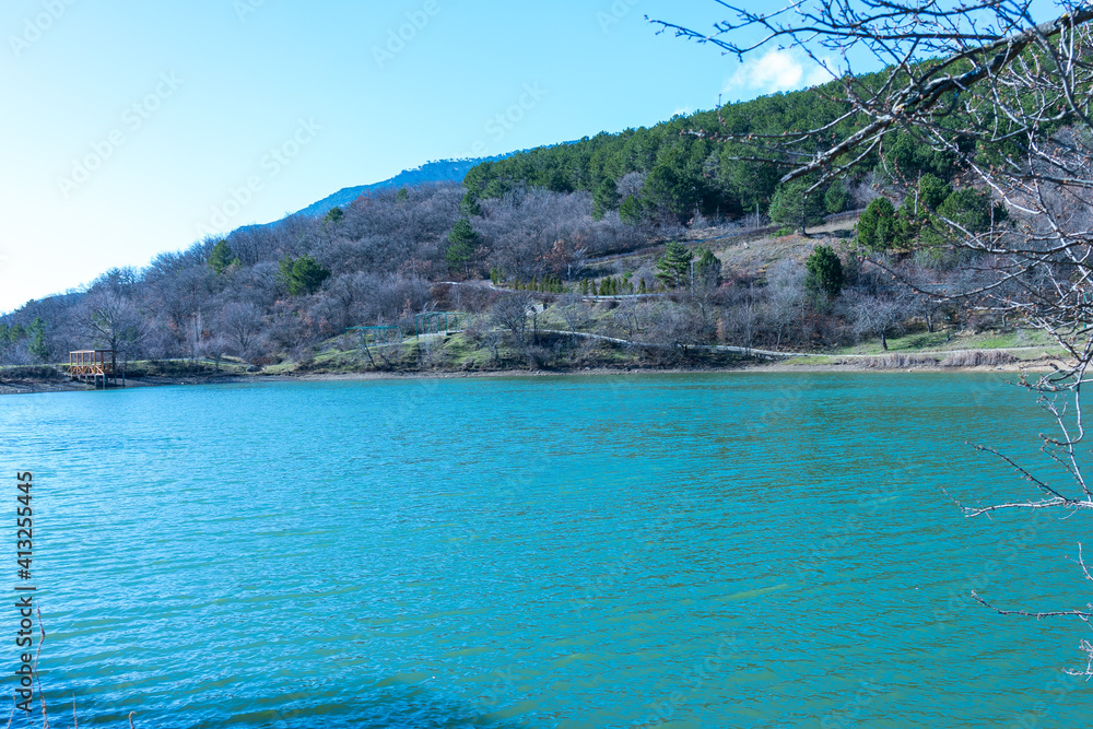 Blue water of a lake located in the mountains in spring