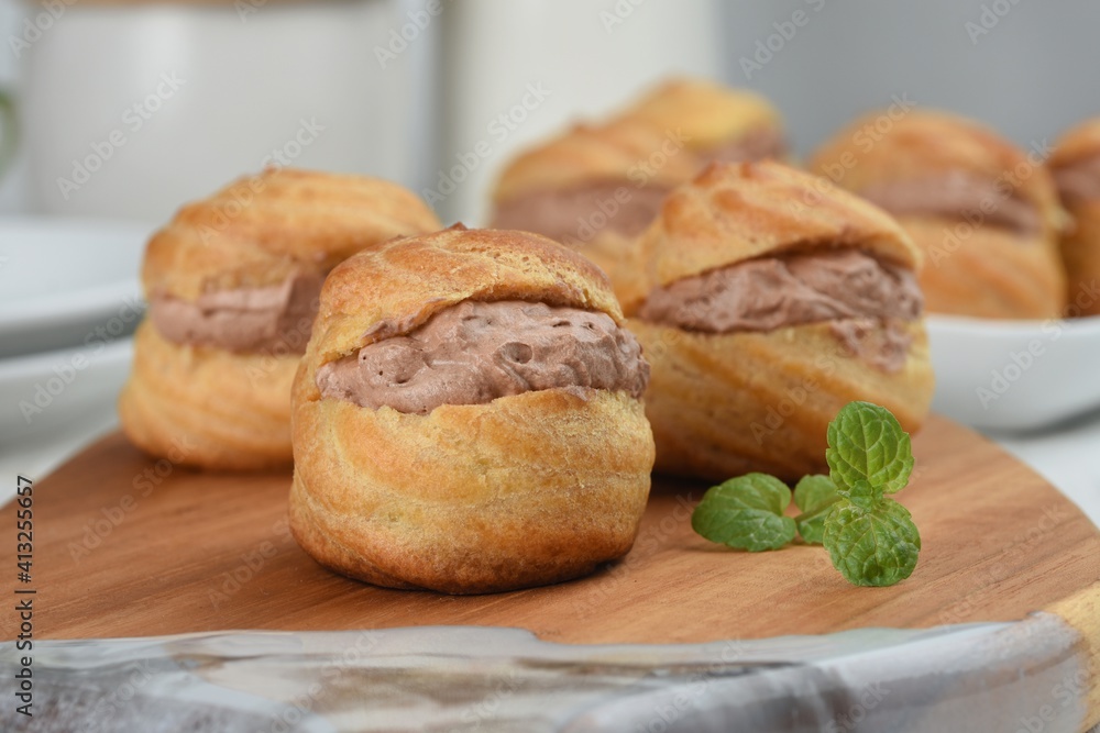 Choux pastry or Cream puffs filled chocolate custard.white background