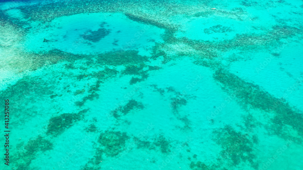 Top view of transparent turquoise ocean water surface. Copy space for text.