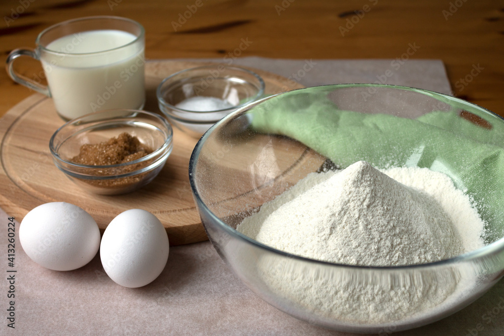The necessary set of ingredients for making pancakes and pancakes eggs flour salt sugar and milk. The necessary set of ingredients for making pancakes and pancakes eggs flour salt sugar and milk.