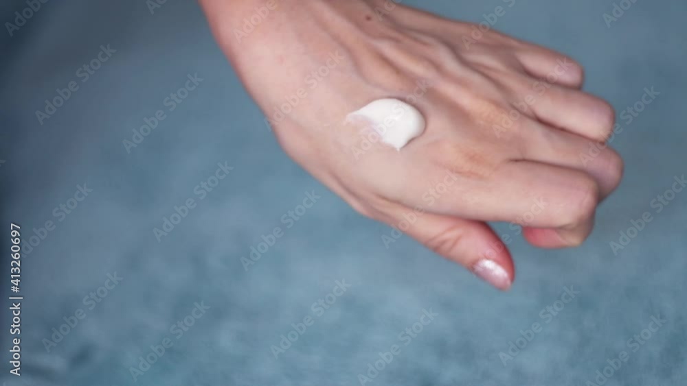 Arms of young woman applying cream. Beautiful female hands studio close-up. Anti-aging, healthcare and rejuvenation Arms of young woman applying cream. Beautiful female hands studio close-up. Anti-aging, healthcare and rejuvenation