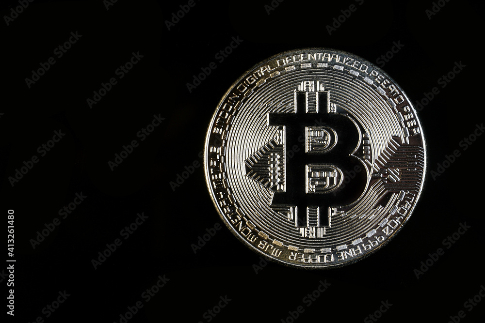A Bitcoin with black background. Bitcoin is a digital cryptocurrency that can be exchanged for other currencies, products or services. A Bitcoin with black background. Bitcoin is a digital cryptocurrency that can be exchanged for other currencies, products or services.