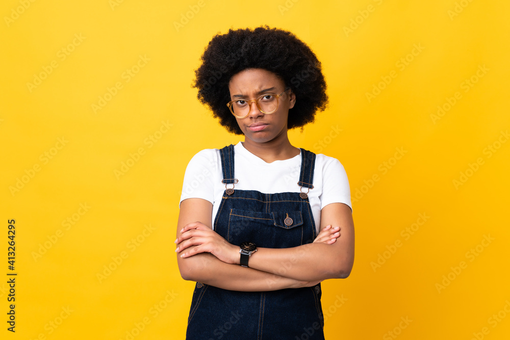 Young African American woman isolated on yellow background feeling upset Young African American woman isolated on yellow background feeling upset
