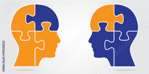 Vector illustration of two heads with puzzle pieces. The two heads are facing each other with two changed puzzle pieces.