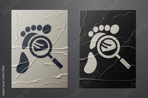 White Magnifying glass with footsteps icon isolated on crumpled paper background. Detective is investigating. To follow in the footsteps. Paper art style. Vector.