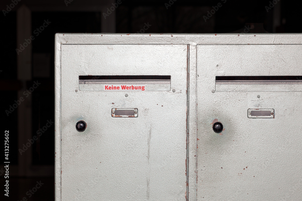 Mailboxes, box container in an entrance to a poor residence, in a residential building. german language sticker Keine Werbung, No Advertisement Mailboxes, box container in an entrance to a poor residence, in a residential building. german language sticker Keine Werbung, No Advertisement