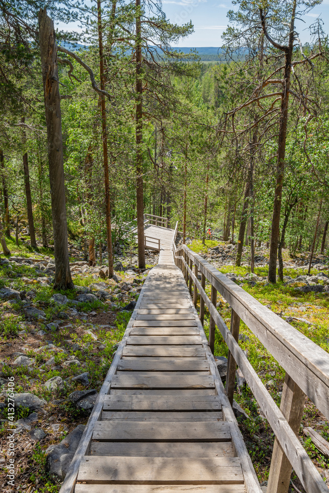 View of The Pyha-Luosto National Park in summer, wooden stairway, trees and rocks, Lapland, Finland View of The Pyha-Luosto National Park in summer, wooden stairway, trees and rocks, Lapland, Finland