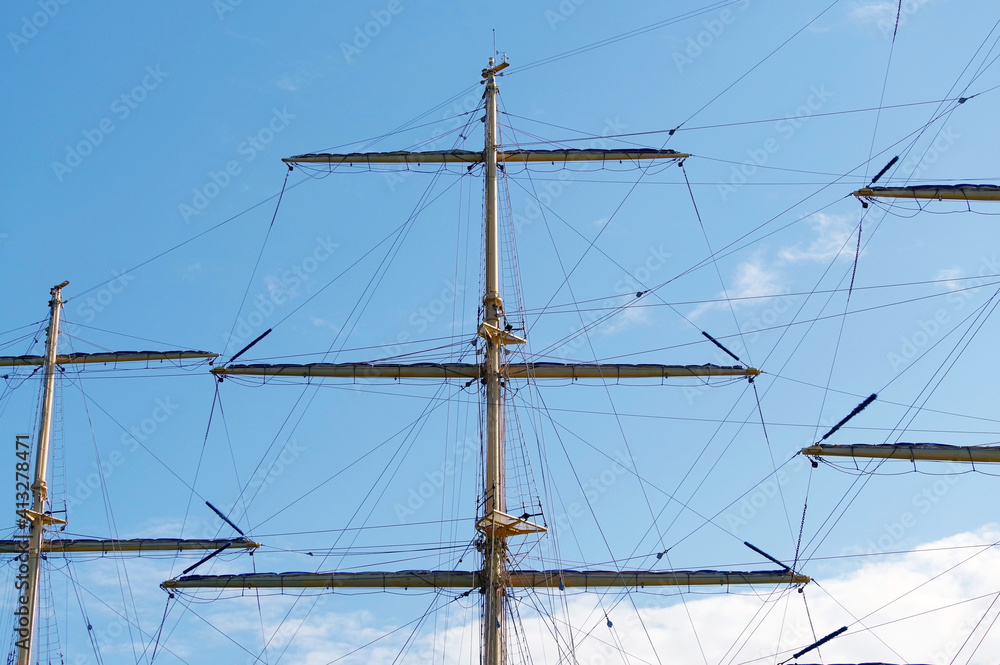 Masts and rigging of a sailing ship against sky Masts and rigging of a sailing ship against sky