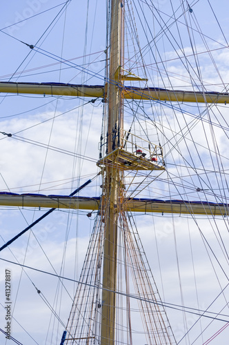 Masts and rigging of a sailing ship against sky