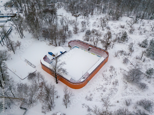 Snowy stadium in the park. Aerial drone view. Winter snowy morning.
