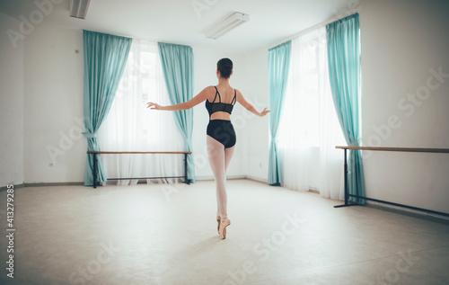 Ballerina doing classical ballet in ballet studio