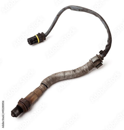 Lambda probe - oxygen sensor device designed to record tamount of remaining oxygen in the exhaust gas of car engine is located in exhaust system. Metal spare part for replacement to repair in workshop