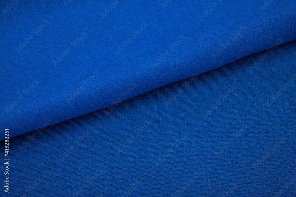 Pleats on fabric, knitted material of bright blue color, folds Pleats on fabric, knitted material of bright blue color, folds