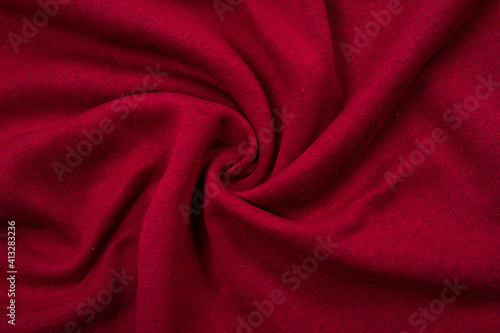 Pleats on fabric, knitted material of Crimson color, folds