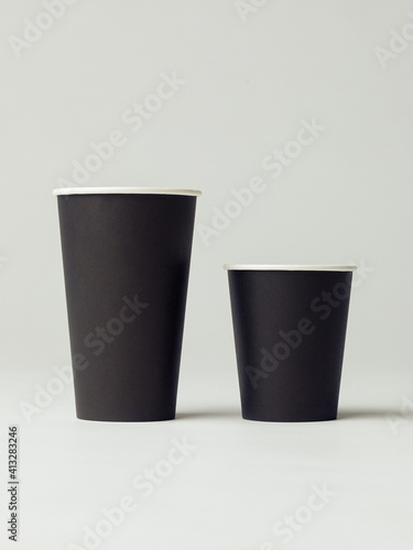 Coffee cup set - mockup template for cafes, design of the restaurant's corporate style. Black cardboard coffee cup mockup. Template disposable plastic and paperware for hot drinks