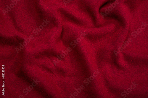 Pleats on fabric, knitted material of Crimson color, folds