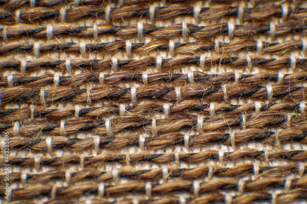 Synthetic fabric fibers for chairs, coarse fabrics, with gaps between fibers. Neat weave Large white-brown fibers , High magnification , Super macro. Synthetic fabric fibers for chairs, coarse fabrics, with gaps between fibers. Neat weave Large white-brown fibers , High magnification , Super macro.