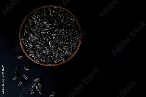 Sunflower seeds in a wooden plate. Healthy food concept.
 photo