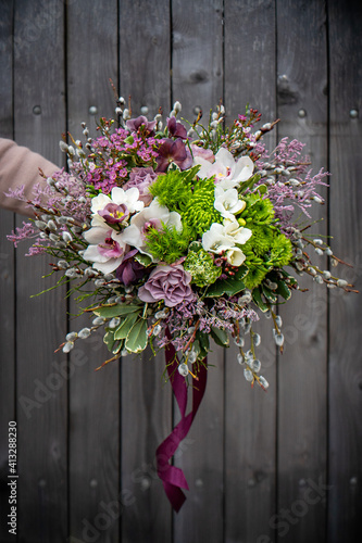 Fototapeta Naklejka Na Ścianę i Meble -  Bouquet of fresh delicate flowers on a dark shady blured background gift