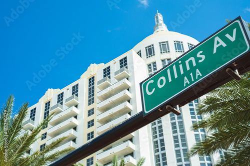Photography Collins Avenue street sign in Miami Beach with palm trees and art deco architect