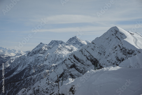 Alpine landscape, slopes of high mountains with glaciers against the blue sky. © Evgenii Starkov