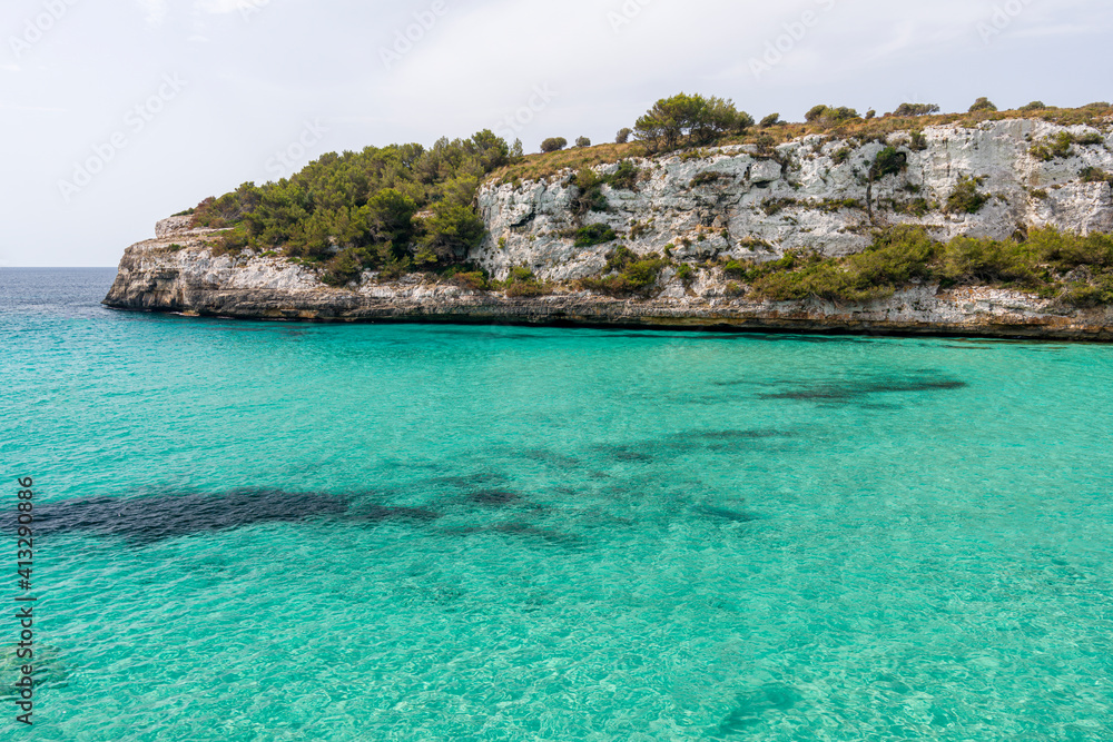 A view on a cliff in Cala Romantica from the trailing path on Mallorca island in Spain