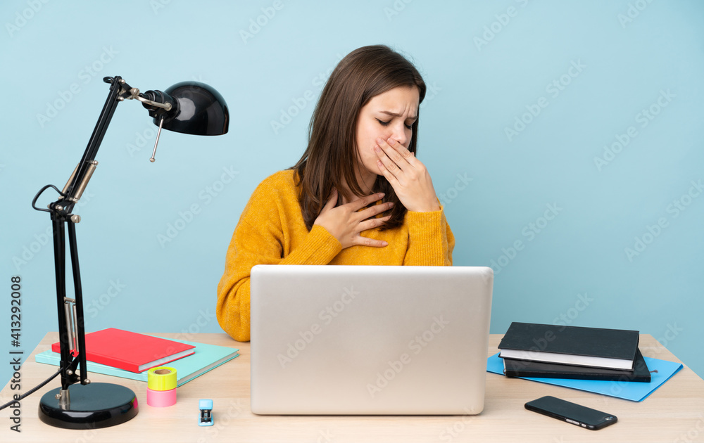 Student girl studying in her house isolated on blue background is suffering with cough and feeling bad Student girl studying in her house isolated on blue background is suffering with cough and feeling bad