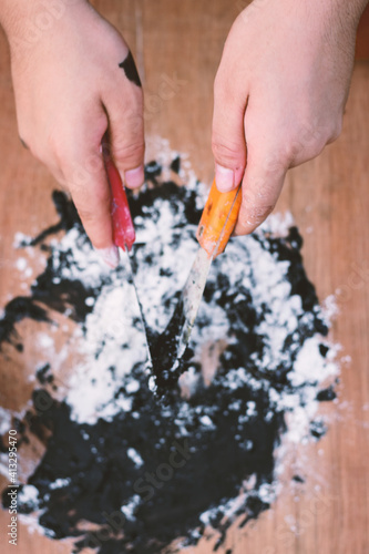 Acrylic black paint and crayon on the wooden floor background, Create art on canvas