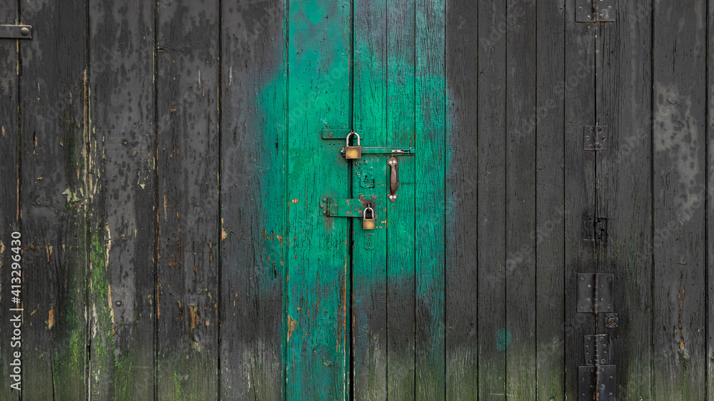 Detail of the locks on an old wooden slat door Detail of the locks on an old wooden slat door