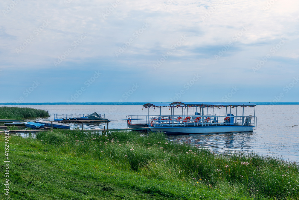boat for tourists ' excursions on the lake is tied up in the reeds on the shore of Lake Nero. Rostov Veliky, Russia