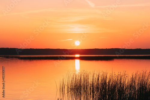 Sundown Above Lake River Horizon At Sunset. Natural Sky In Warm Colors Water. Sun Waters