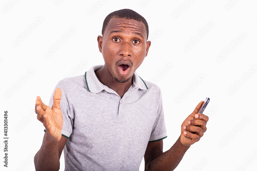 handsome shocked young man holding mobile phone. handsome shocked young man holding mobile phone.