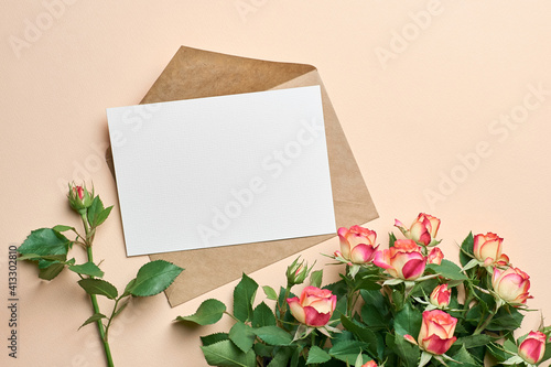 Greeting card mockup with fresh roses bouquet on paper background