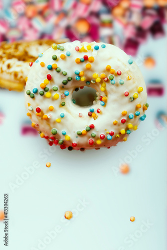 Donuts decorated icing and sprinkles on the white background
