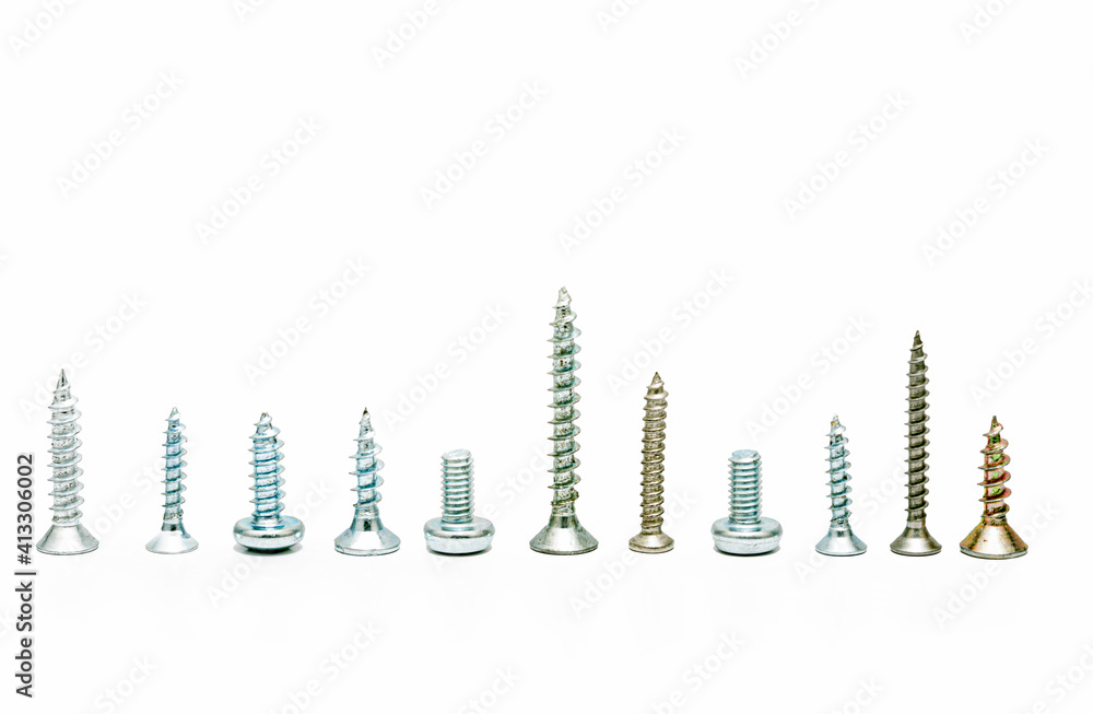 Different screws and bolts on a white background Different screws and bolts on a white background