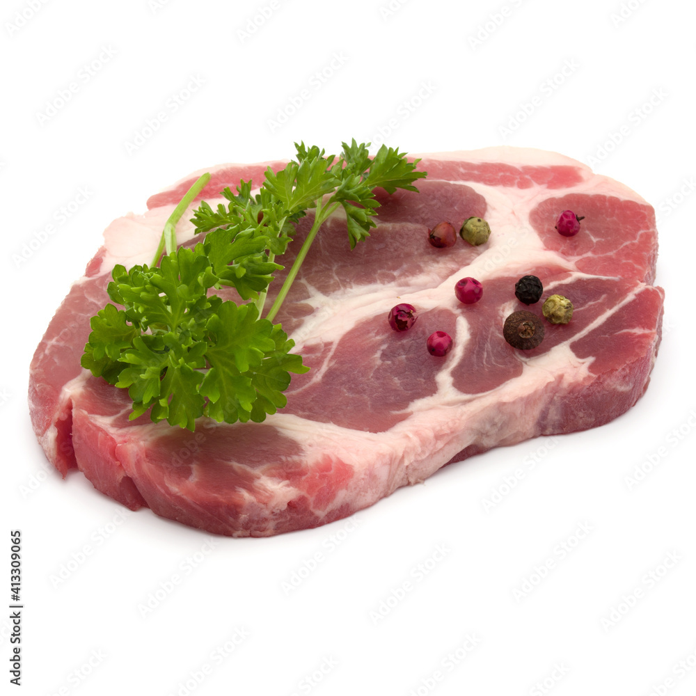 Raw pork neck chop meat with parsley herb leaves and peppercorn spices garnish isolated on white background cutout Raw pork neck chop meat with parsley herb leaves and peppercorn spices garnish isolated on white background cutout
