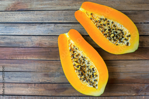 Fresh sliced papaya fruit on wooden background.Tropical fruit. Top view.