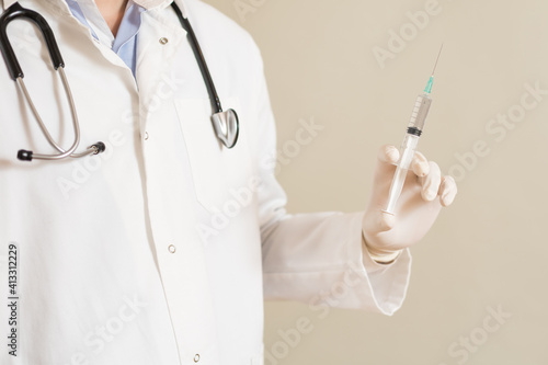Image of male doctor holding injection.