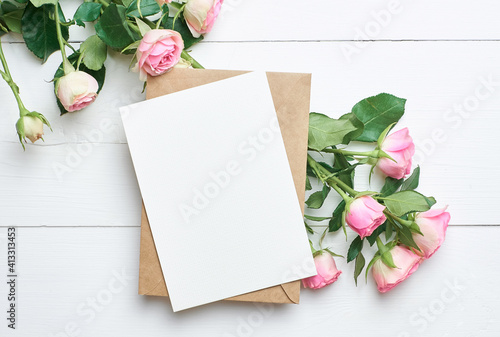 Greeting card with fresh roses on white background, mockup with copy space