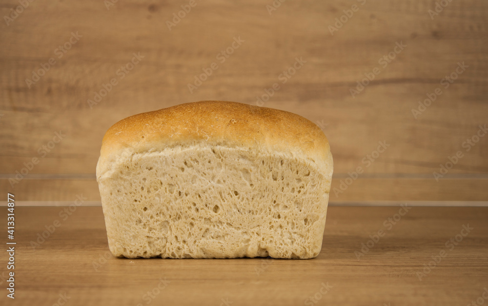 Fresh out of the oven loaf of homemade whole wheat bread on a wooden table Fresh out of the oven loaf of homemade whole wheat bread on a wooden table