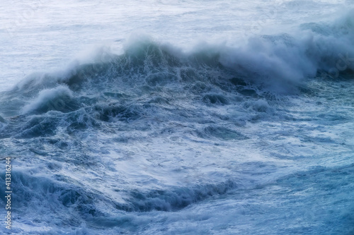 giant waves breaking on a stormy day in atlantic sea ocean